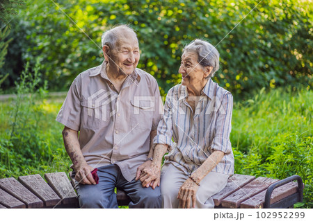 Elderly couple in love. Senior husband and wife holding hands and bonding with true emotions Elderly couple in love. Senior husband and wife holding hands and bonding with true emotions 102952299