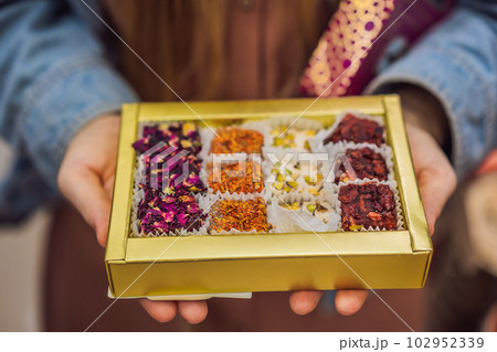 Traditional oriental sweet pastry cookies, nuts, dried fruits, pastilles, marmalade, Turkish desert with sugar, honey and pistachio, in display at a street food market 102952339