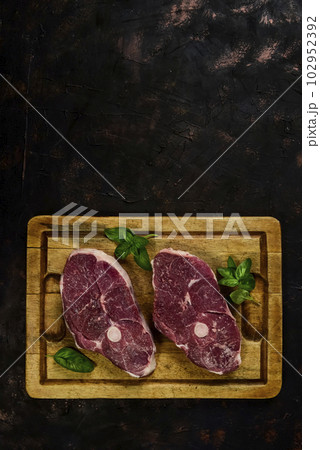 Patagonian lamb meat presented on the wooden table, Patagonia Argentina. Patagonian lamb meat presented on the wooden table, Patagonia Argentina. 102952392