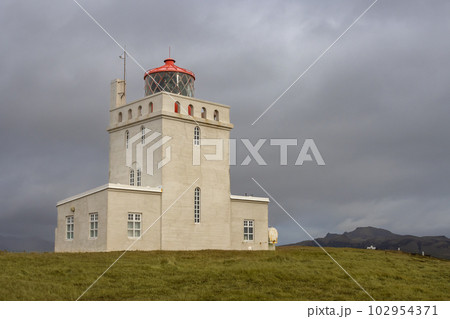 Dyrholaey Lighthouse and cloudy sky, Iceland Dyrholaey Lighthouse and cloudy sky, Iceland 102954371