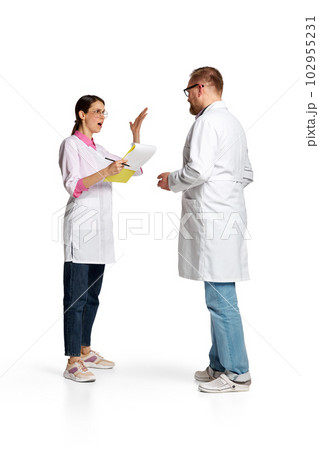 Portrait of woman and man, doctors in white lab coat arguit on medical questions isolated over white background 102955231