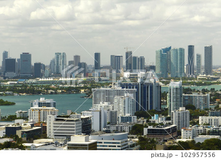 Aerial view of downtown office district of Miami in Florida, USA on bright sunny day. High commercial and residential skyscraper buildings in modern american megapolis 102957556
