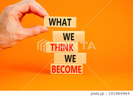 We become or think symbol. Concept word What we think We become on wooden block. Beautiful orange table orange background. Businessman hand. Business we become or think concept. Copy space. We become or think symbol. Concept word What we think We become on wooden block. Beautiful orange table orange background. Businessman hand. Business we become or think concept. Copy space. 102964964