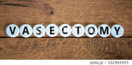Vasectomy symbol. Concept words Vasectomy on white circles. Beautiful wooden table wooden background. Medical and vasectomy problem concept. Conceptual image. Copy space. 102964995