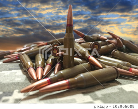 pile of bullets against cloudy sunset. Military concept. War is threat to peace pile of bullets against cloudy sunset. Military concept. War is threat to peace 102966089