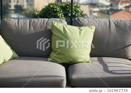 modern grey sofa with pillows in living room at home 102967739