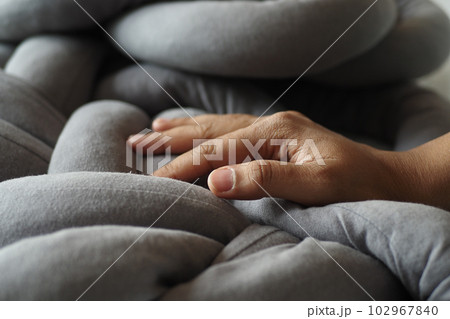 hand on gray color pillow hand on gray color pillow 102967840