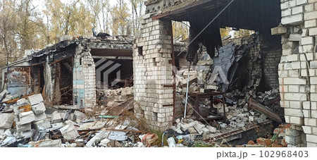 Destruction in wall of multi-storey building after being hit by artillery shell Destruction in wall of multi-storey building after being hit by artillery shell 102968403