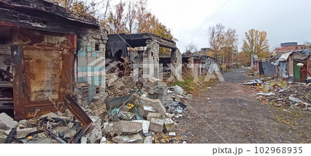 Burnt cars in destroyed garages during war in Ukraine. Russian-Ukrainian War 102968935