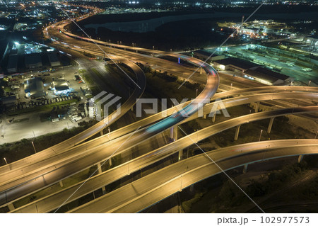 Aerial view of american freeway intersection at night with fast driving cars and trucks in Tampa, Florida. View from above of USA transportation infrastructure Aerial view of american freeway intersection at night with fast driving cars and trucks in Tampa, Florida. View from above of USA transportation infrastructure 102977573