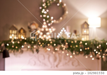 Abstract blur. Christmas tree. Close-up a small house, Cones, garland, and other Christmas tree toys. light from the garlands Abstract blur. Christmas tree. Close-up a small house, Cones, garland, and other Christmas tree toys. light from the garlands 102981550
