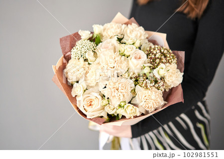 Beautiful bouquet of flowers in woman hand. Floral shop concept . Beautiful fresh cut bouquet. Flowers delivery 102981551