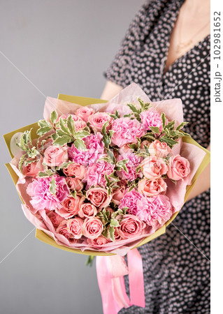 Beautiful bouquet of mixed flowers in woman hand. Floral shop concept . Beautiful fresh cut bouquet. Flowers delivery 102981652