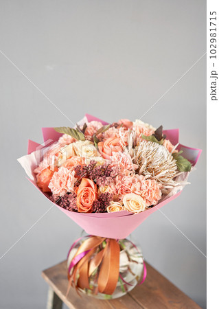 Finished flower arrangement in a vase for home. Flowers bunch, set for interior. Fresh cut flowers for decoration home. European floral shop. Delivery fresh cut flower. Finished flower arrangement in a vase for home. Flowers bunch, set for interior. Fresh cut flowers for decoration home. European floral shop. Delivery fresh cut flower. 102981715