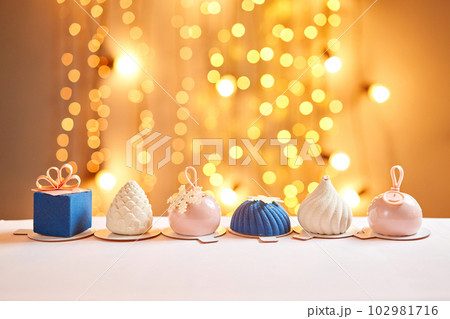 Merry Christmas card. Variety of sweet delicious cakes. Fir branches on a gray background. Merry Christmas card. New year mood Merry Christmas card. Variety of sweet delicious cakes. Fir branches on a gray background. Merry Christmas card. New year mood 102981716