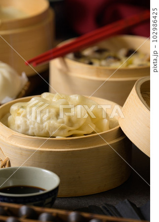 Chinese steamed pork shumai. Bamboo steamers with assorted dim sum, Chinese cuisine 102986425