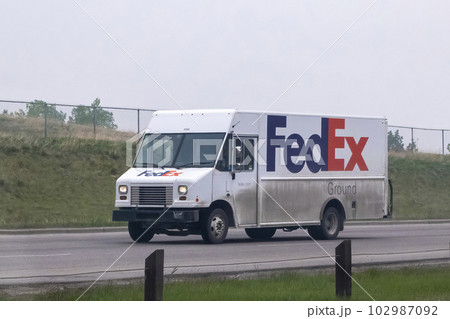 Calgary, Alberta, Canada. May 17, 2023. A FedEx delivery shipping truck van on the route. Calgary, Alberta, Canada. May 17, 2023. A FedEx delivery shipping truck van on the route. 102987092