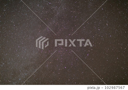 Night and cloudless sky with lots of bright stars. 102987567