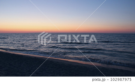 Sunset on Baltic Sea. Waves on seashore in evening Sunset on Baltic Sea. Waves on seashore in evening 102987975
