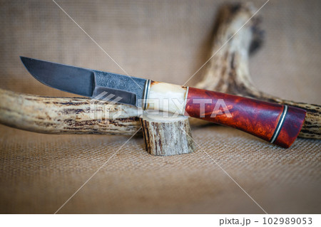 hunting knife handmade on a brown background 102989053