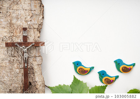 Christian Pentecost. Whit Sunday. A cross with a birch branch on a white, green, red and black background. Christian Pentecost. Whit Sunday. A cross with a birch branch on a white, green, red and black background. 103005882
