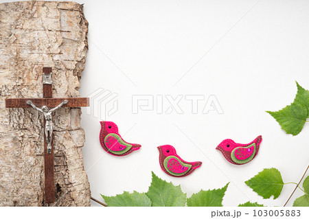 Christian Pentecost. Whit Sunday. A cross with a birch branch on a white, green, red and black background. Christian Pentecost. Whit Sunday. A cross with a birch branch on a white, green, red and black background. 103005883