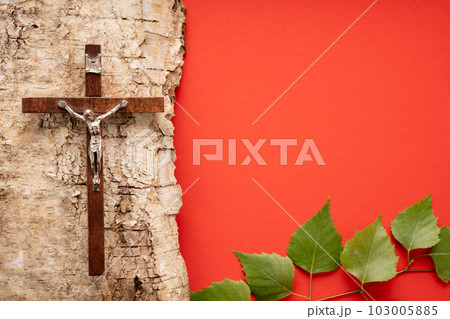 Christian Pentecost. Whit Sunday. A cross with a birch branch on a white, green, red and black background. Christian Pentecost. Whit Sunday. A cross with a birch branch on a white, green, red and black background. 103005885