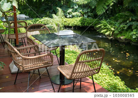 Cafe patio by pond with tree decoration of outdoor restaurant Cafe patio by pond with tree decoration of outdoor restaurant 103008565