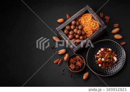 Roasted pecans and macadamia nuts, dried tangerine, dried berries Roasted pecans and macadamia nuts, dried tangerine, dried berries 103012821