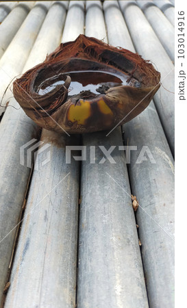 The fibrous outer skin of the coconut is placed on a galvanized pipe outside so that can hold water when rain come. 103014916