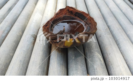 The fibrous outer skin of the coconut is placed on a galvanized pipe outside so that can hold water when rain come. 103014917