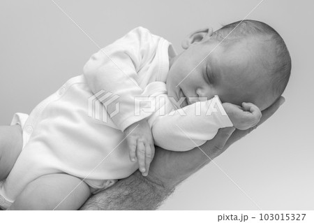 Father Holding sleeping Newborn Baby on his hand 103015327