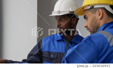 Professional electricians workers with safety helmet talking and brainstorming Professional electricians workers with safety helmet talking and brainstorming 103016955
