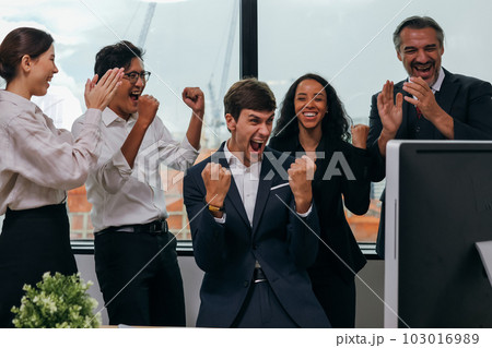 Happy business employees team celebrating success with praise in meeting room 103016989