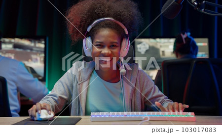 Game streamer using pc setup playing multiplayer first person shooter 103017083