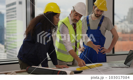 Professional construction engineers team using blueprint of project plan Professional construction engineers team using blueprint of project plan 103017084