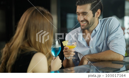 Couple of handsome man and beautiful woman drinking cocktails in luxury bar Couple of handsome man and beautiful woman drinking cocktails in luxury bar 103017164