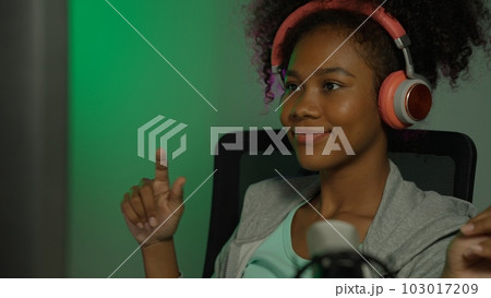 Game streamer using pc setup playing multiplayer first person shooter 103017209