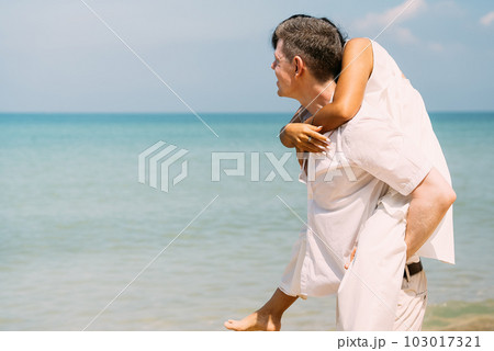 Man and woman enjoying with honeymoon trip at beach Man and woman enjoying with honeymoon trip at beach 103017321