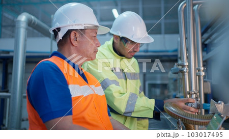 Engineer specialist checking and controlling machine in industrial factory Engineer specialist checking and controlling machine in industrial factory 103017495
