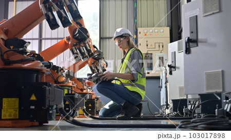 Maintenance engineer worker working with robotic machine at factory Maintenance engineer worker working with robotic machine at factory 103017898