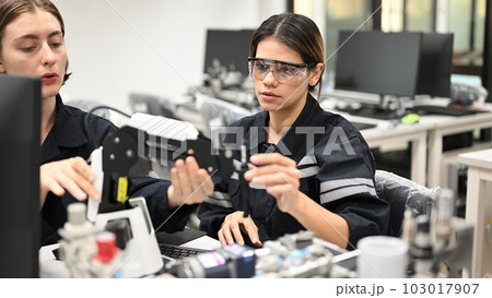 Industrial technicians working with machine maintenance 103017907