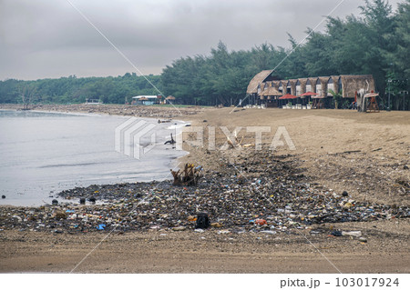 Polluted beach. The problem of global ocean pollution. A pile of plastic debris is scattered on the shores of the Indian Ocean on the island of Bali in Indonesia. Polluted beach. The problem of global ocean pollution. A pile of plastic debris is scattered on the shores of the Indian Ocean on the island of Bali in Indonesia. 103017924
