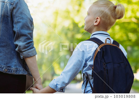 mother and son going to school holding hands 103019808