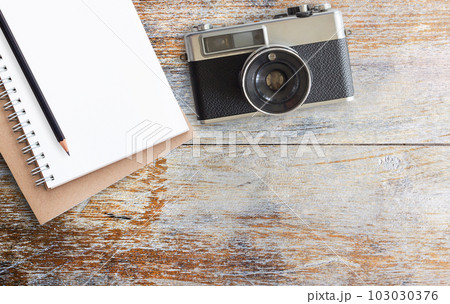 Office desk table with camera and notepad Office desk table with camera and notepad 103030376