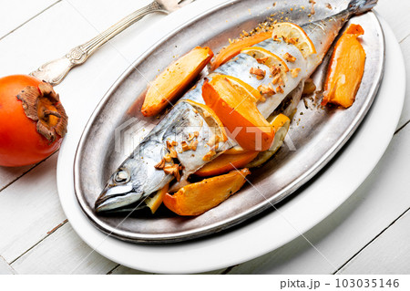 Mackerel fish baked with fruits. 103035146