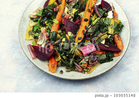 Vegetarian warm salad of stewed vegetables and chard leaves. 103035148