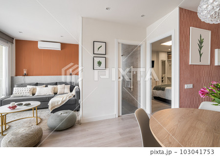 Modern living room with lounge area with dining round table and decorative accessories in a modern urban residential complex with open bedroom and bathroom in european country Modern living room with lounge area with dining round table and decorative accessories in a modern urban residential complex with open bedroom and bathroom in european country 103041753