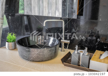 bathroom with black marble sink and marble wall 103042197