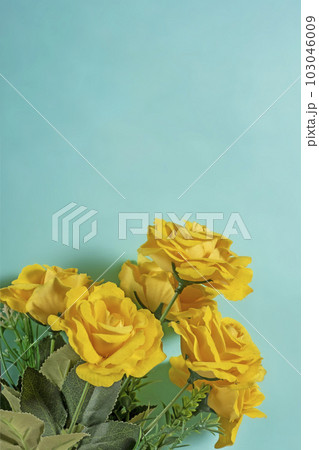 Bouquet of yellow roses on turquoise background with copy space Bouquet of yellow roses on turquoise background with copy space 103046009